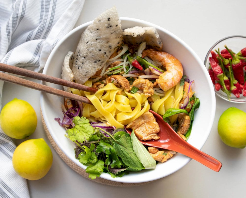 Mi Quang is a signature dish of Da Nang featuring turmeric-infused noodles, rich broth, and flavorful toppings